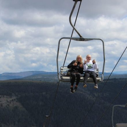 Female students riding a ski lift
