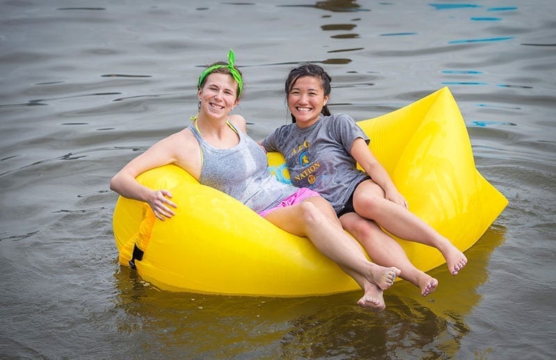 Students floating in a raft on the river.