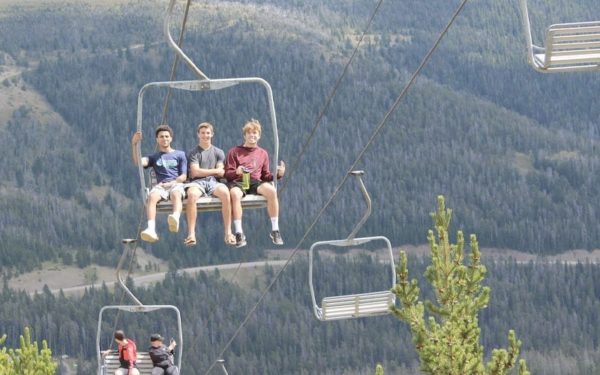 University of Providence students riding a ski lift