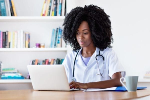 Researching african american medical female student at computer