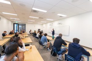 Students are engaged in a business course inside a University of Providence classroom.